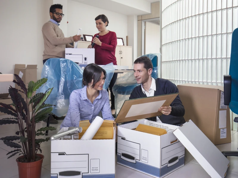 Employees collaborating during office move