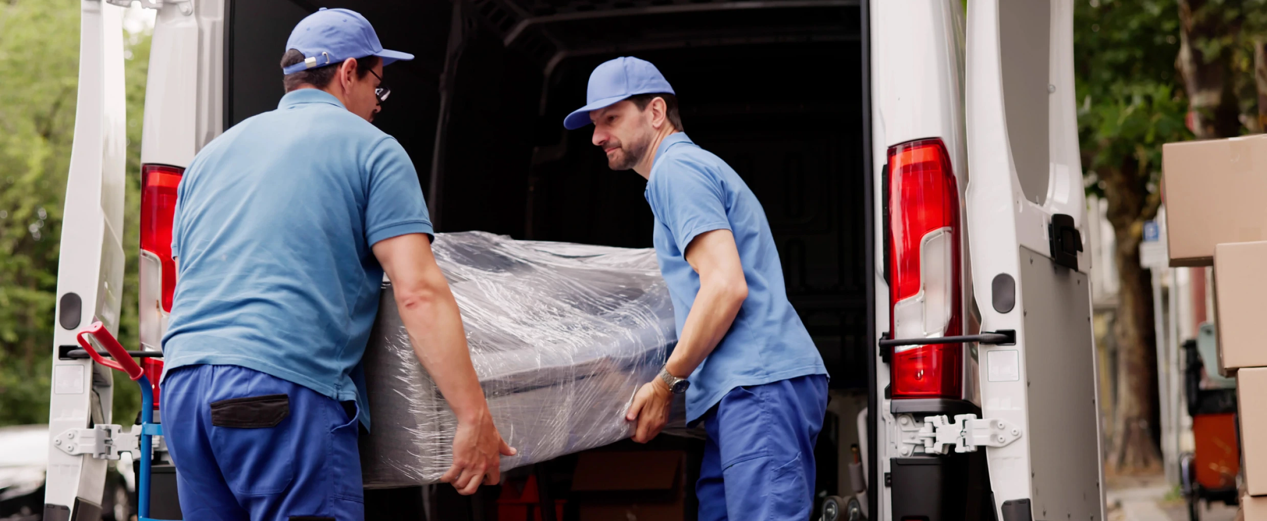 Movers loading furniture into van